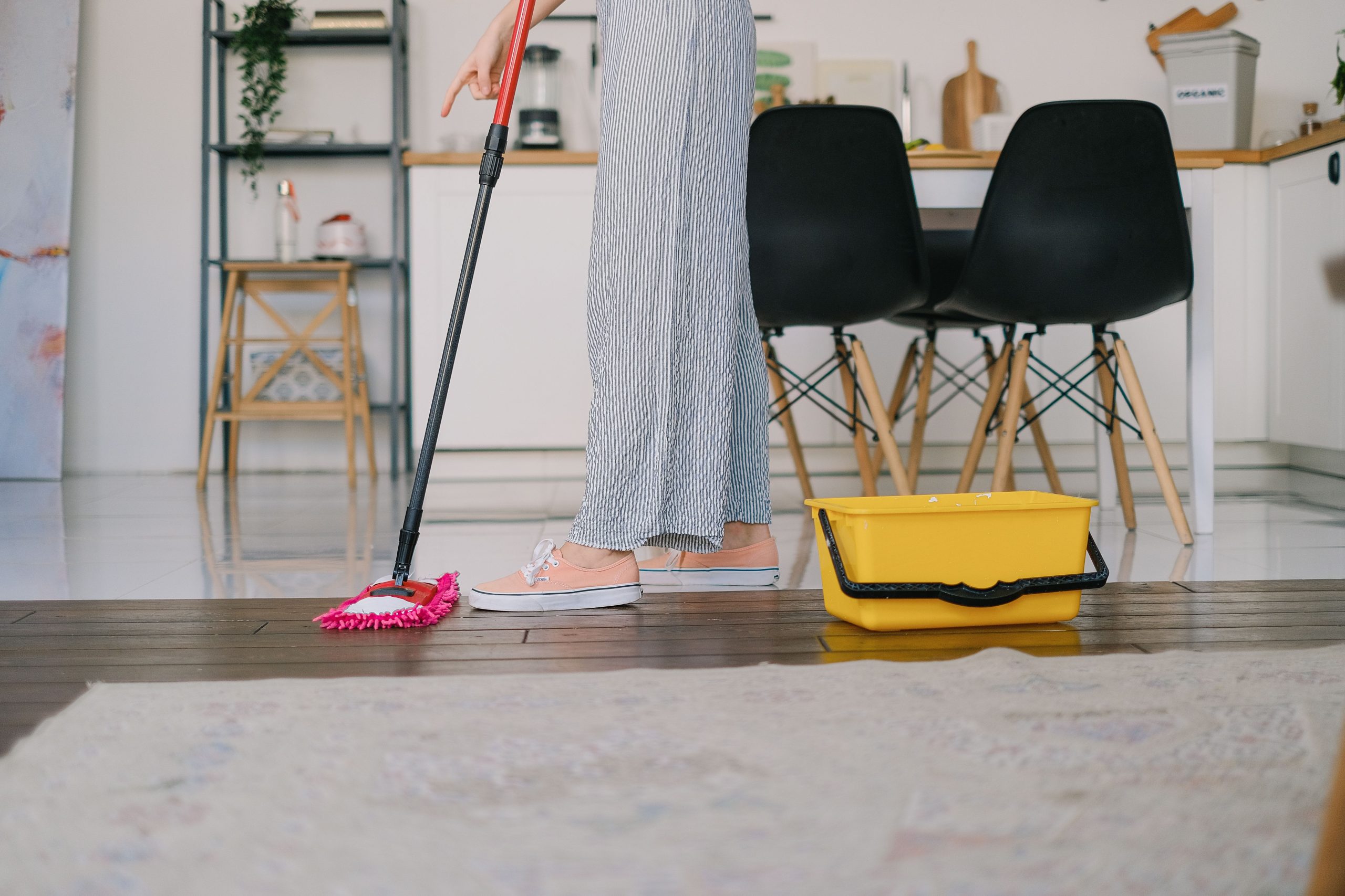 A woman mopping the floor